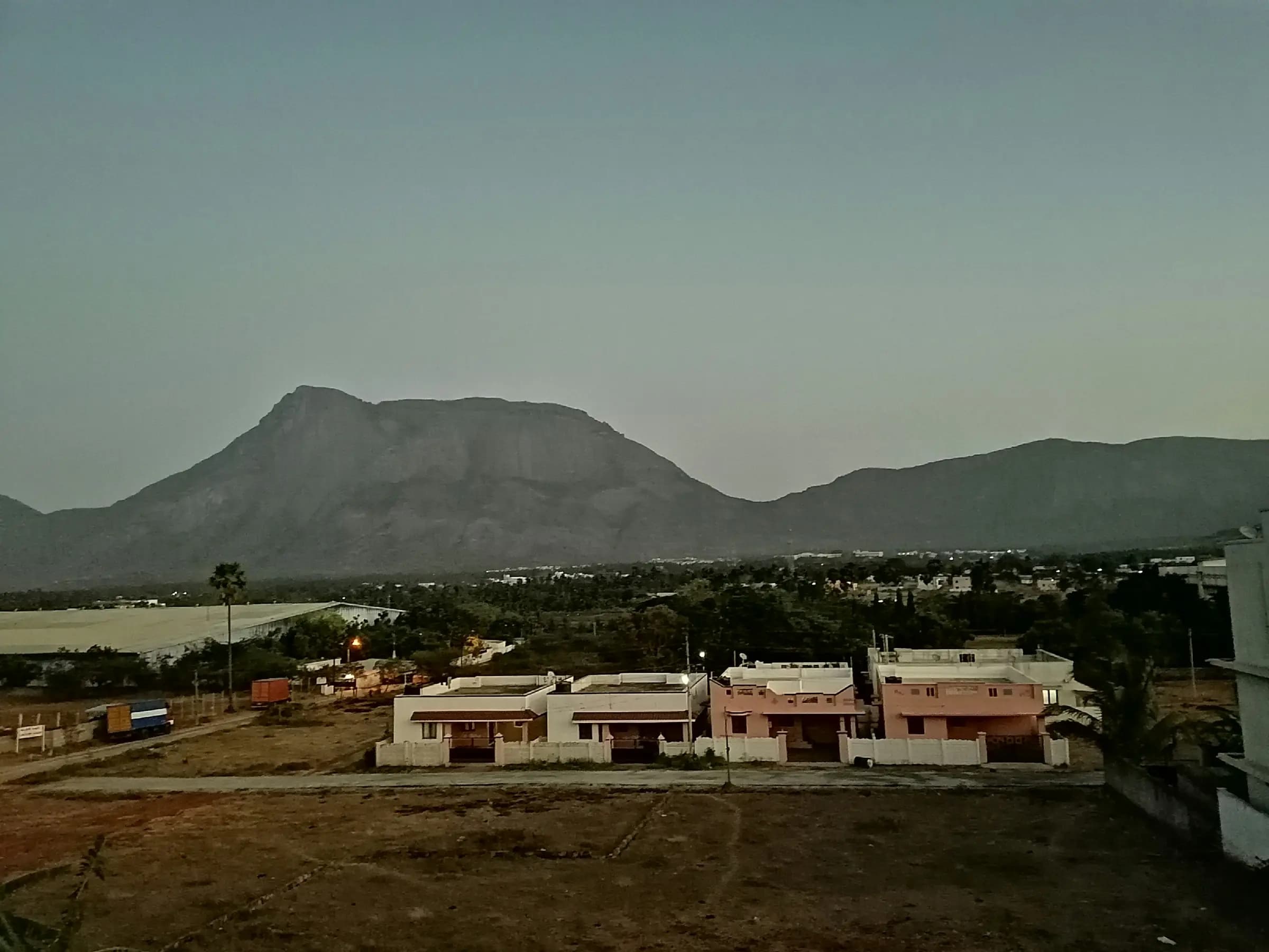 Row of homes beneath rocky hills, Coimbatore