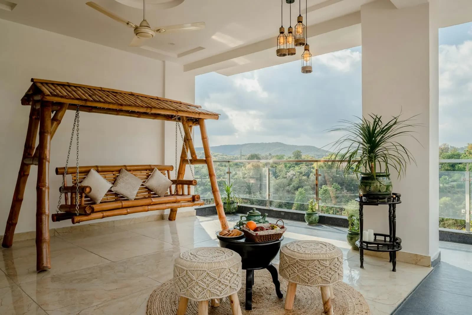 Balcony with a wooden swing and a hill view